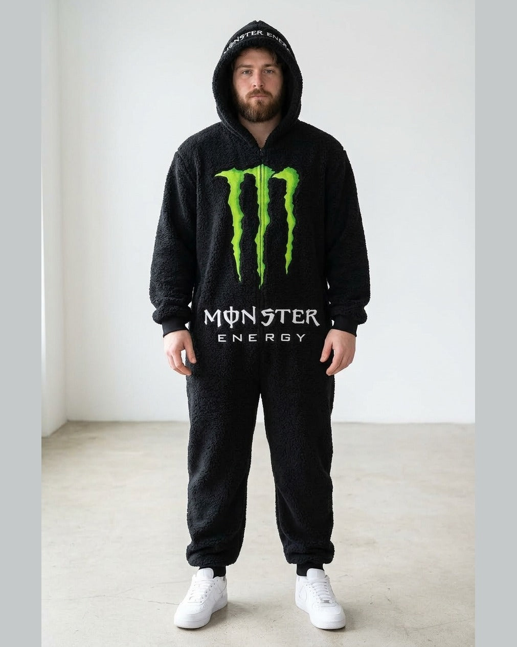 Blackout sherpa onesie on a male model, full length